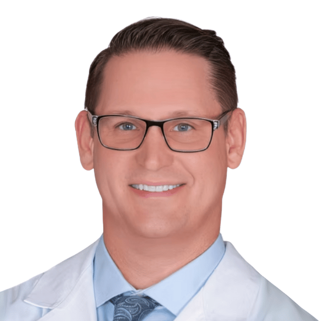 Smiling doctor in a white coat with glasses.